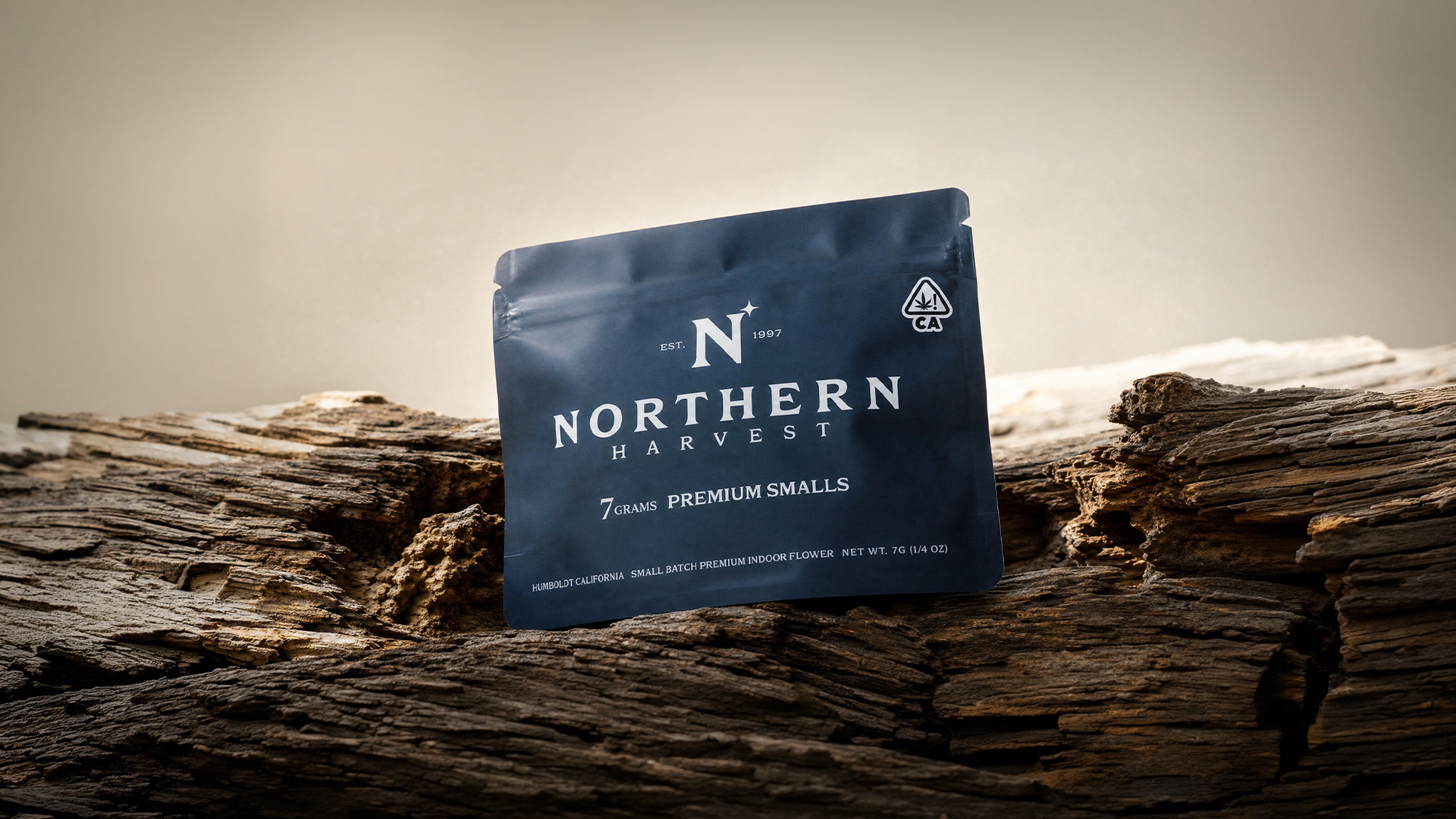 Northern Harvest 7g premium smalls mylar pouch resting on driftwood at dusk in Humboldt, California